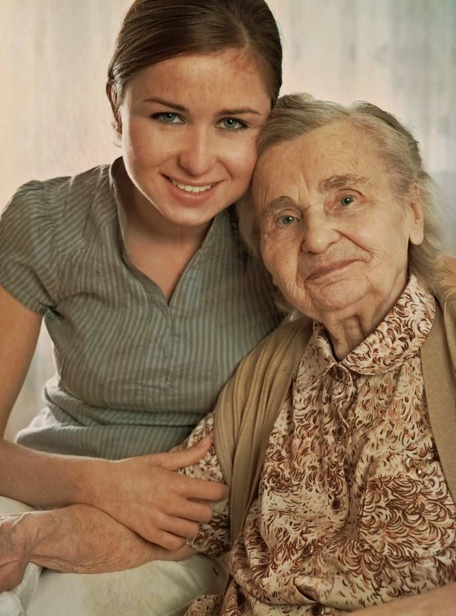 caregiver and client hugging and smiling